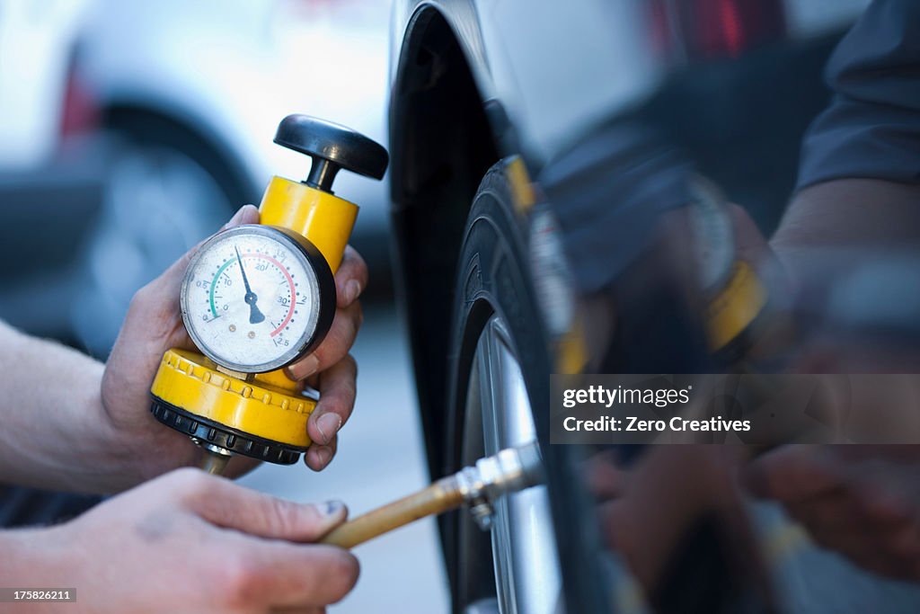 Person using pressure gauge