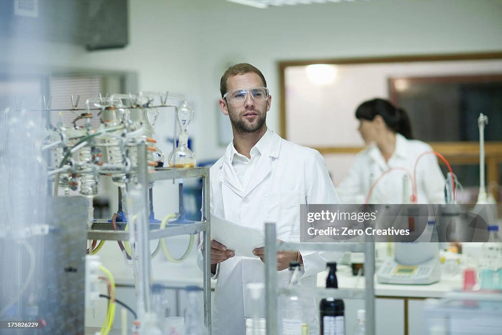 Oenologists monitoring sample testing in laboratory