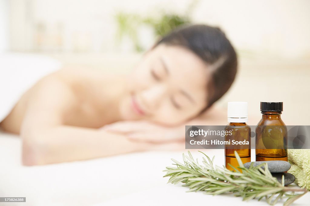 Aromatherapy oils with woman in background