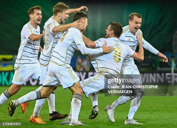 Saarbruecken's players celebrate after winning the German Cup second round football match 1 FC Saarbruecken v FC Bayern Munich at Ludwigspark stadium...