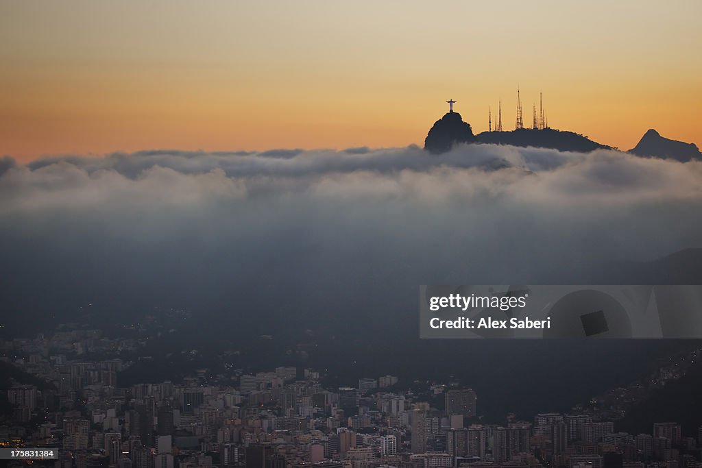 Christ the Redeemer statue above Rio de Janeiro at sunset.