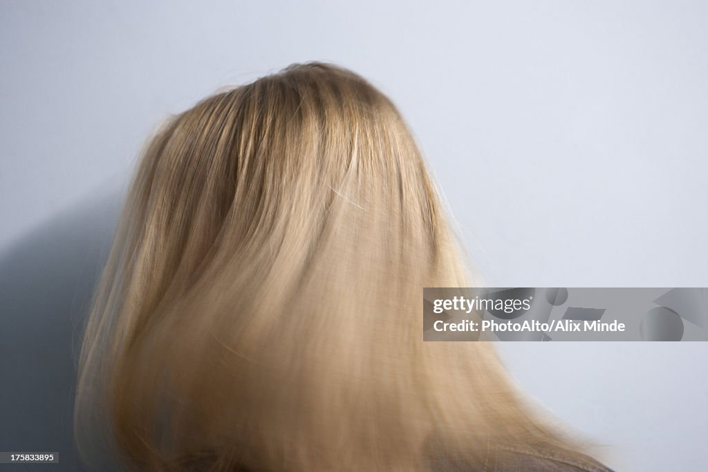 Woman tossing blonde hair