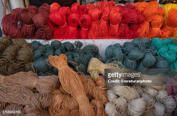 high angle view of multi colored rope bundles at a market stall. - jute stock pictures, royalty-free photos & images