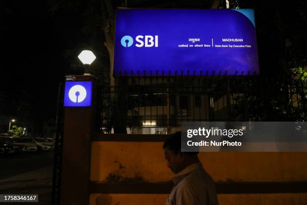 Man walks past a State bank of India signage in Mumbai, India, 01 November, 2023. India's largest lender, State Bank of India , has announced that it...