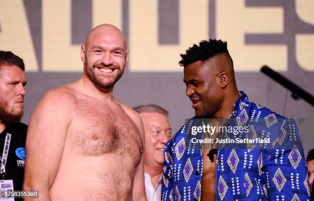 Tyson Fury and Francis Ngannou react in the face off during a press conference ahead of the Tyson Fury v Francis Ngannou boxing match at Boulevard...