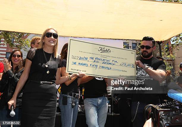 Actress Sharon Stone and Kiehl President Chris Salgardo attend the 4th annual Kiehl's LifeRide for amfAR at The Grove on August 8, 2013 in Los...