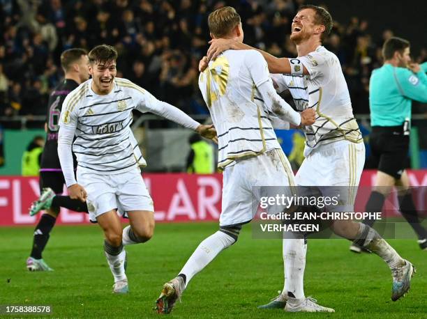 Saarbruecken's players including Saarbruecken's German defender Manuel Zeitz and Saarbruecken's German defender Lukas Boeder celebrate after winning...