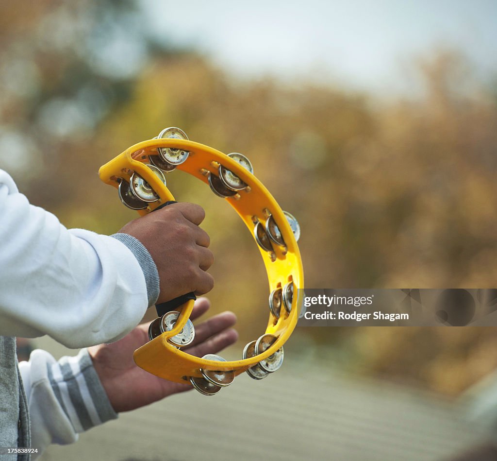 A hand holding and shaking a tambourine, Cape Town, South Africa