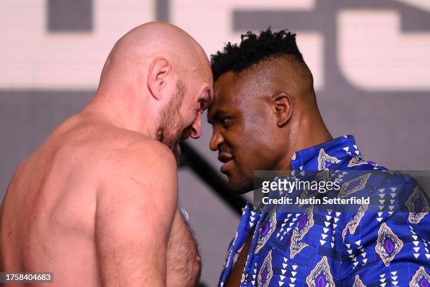 Tyson Fury and Francis Ngannou face off during a press conference ahead of the Tyson Fury v Francis Ngannou boxing match at Boulevard Hall on October...