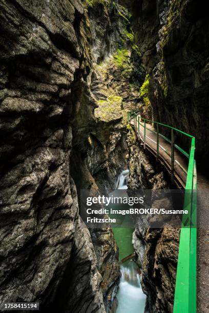 the breitachklamm gorge with the breitach river in autumn at a narrow point. high rock walls on both sides, the circular path on the right. waterfalls in the river with long exposure. oberstdorf, allgaeu. bavaria, germany - breitachklamm canyon stock pictures, royalty-free photos & images