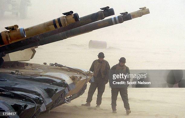Marine Corps 1st Tank Battallion M1/A1 Abrahms tank teams wait for a blinding sand storm to subside during an exercise February 3, 2003 near the...