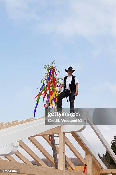 europe, germany, rhineland palatinate, man celebrating topping out ceremony - topping out ceremony stock pictures, royalty-free photos & images