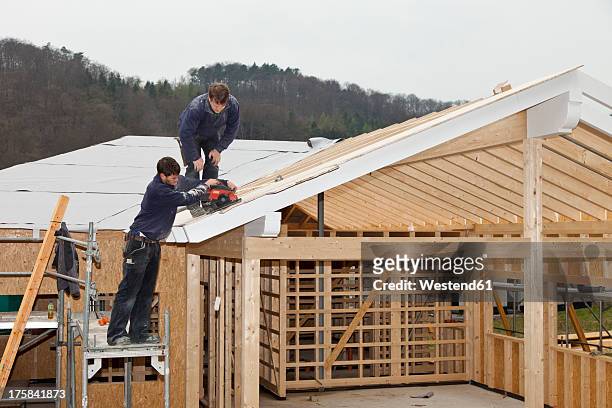 europe, germany, rhineland palatinate, workers roofing on house - roof truss stock pictures, royalty-free photos & images