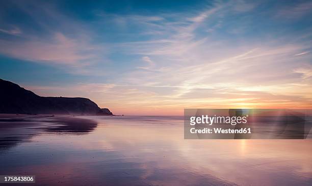 portugal, view of praia do castelejo at sunset - sunset stock-fotos und bilder
