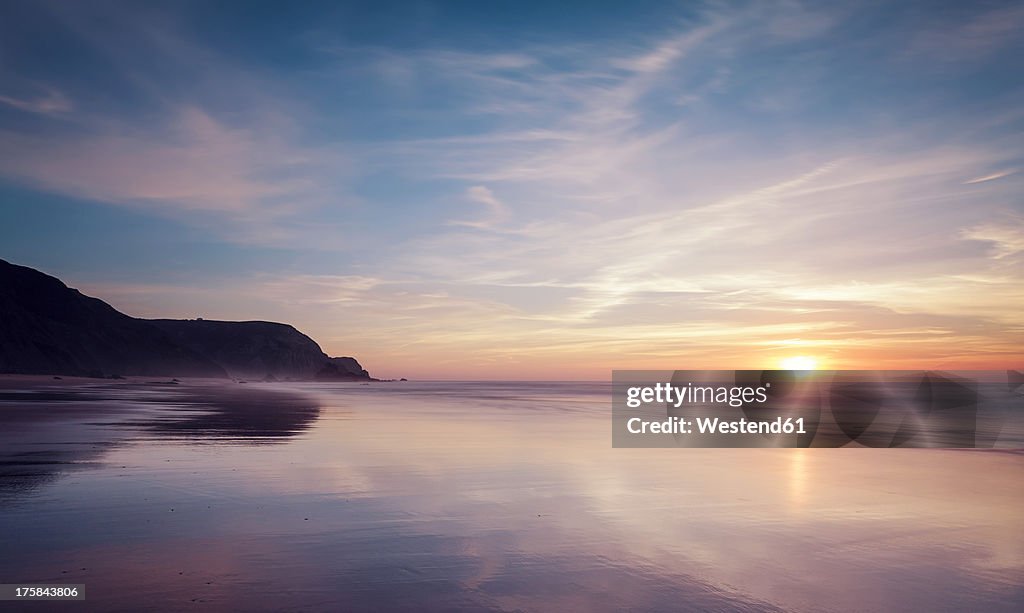 Portugal, View of Praia do Castelejo at sunset