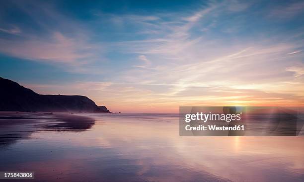 portugal, view of praia do castelejo at sunset - sunset dusk stock pictures, royalty-free photos & images