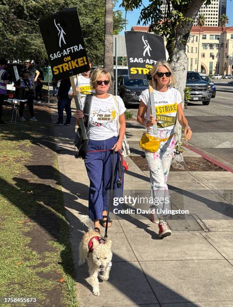 Martha Plimpton and Ever Carradine join the picket line outside Warner Bros. Studios on October 26, 2023 in Burbank, California. SAG-AFTRA has been...