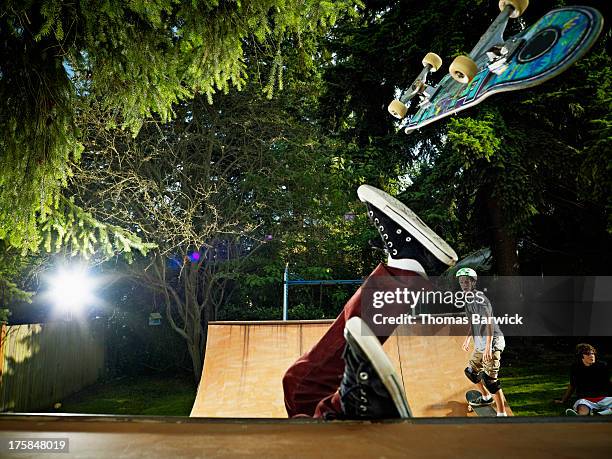 skater falling off skateboard on backyard halfpipe - woodies 10 for 16 show stock pictures, royalty-free photos & images