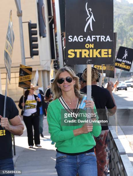 Tricia Helfer joins the picket line outside Warner Bros. Studios on October 26, 2023 in Burbank, California. SAG-AFTRA has been on strike since July...