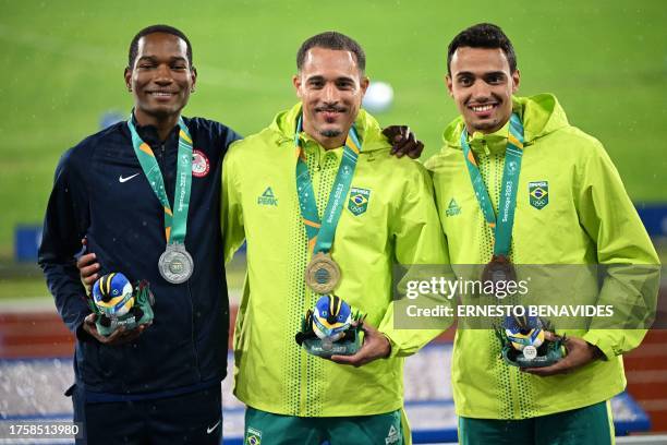 DeVion Wilson, Brazil's Eduardo Rodrigues and Brazil's Rafael Henrique Campos Pereira pose on the podium with their silver, gold, and bronze medals,...