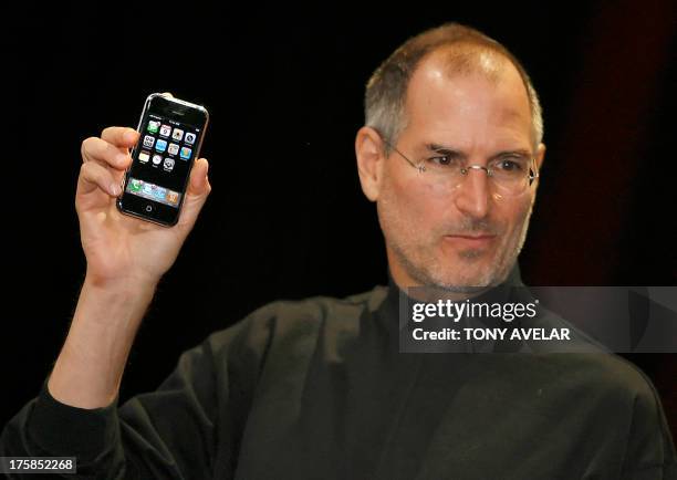 Apple chief executive Steve Jobs unveils a new mobile phone that can also be used as a digital music player and a camera, a long-anticipated device...