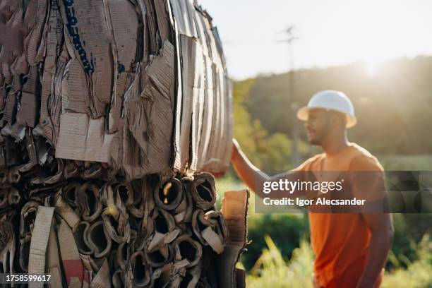 man inspecting a batch of cardboard for recycling - wellpapp bildbanksfoton och bilder