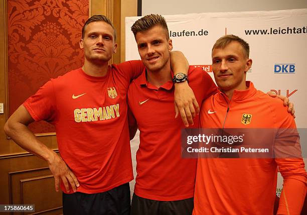 Germany athletes Pascal Behrenbruch, Rico Freimuth and Michael Schrader pose together following a press conference ahead of the 14th IAAF World...