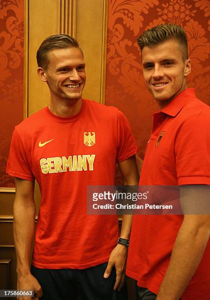Germany athletes Pascal Behrenbruch and Rico Freimuth talk following a press conference ahead of the 14th IAAF World Championships at the Golden Ring...