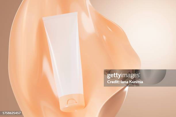 face cream, foundation makeup in white tube, template bottle on background of beige splashes. cosmetic products for skincare. 3d pattern. copy space, place for text. design element. - creme tube ストックフォトと画像