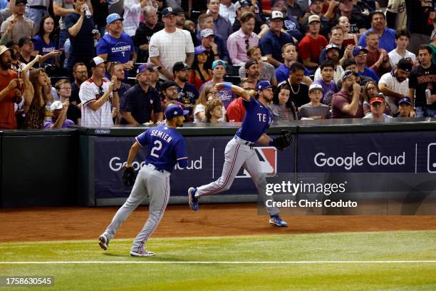 Travis Jankowski of the Texas Rangers fields the ball in the fourth inning during Game 5 of the 2023 World Series between the Texas Rangers and the...