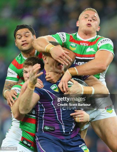 Jason Ryles of the Storm is tackled during the round 22 NRL match between the Melbourne Storm and the South Sydney Rabbitohs at AAMI Park on August...