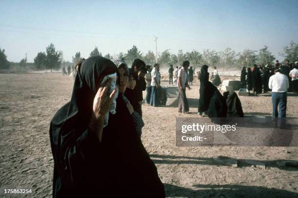 Veiled women cry, 09 September 1978, in the graveyard "Zehra's heaven" in Tehran, during the burial of Ayatollah Khomeiny's supporters who died...