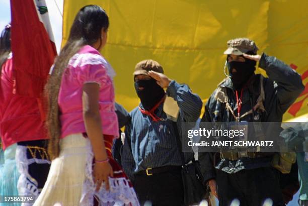 Subcommander Marcos salutes the Mexican flag, carreid by Purepehchas Indigenous during the inauguration of the Third Indigenous National Congress in...