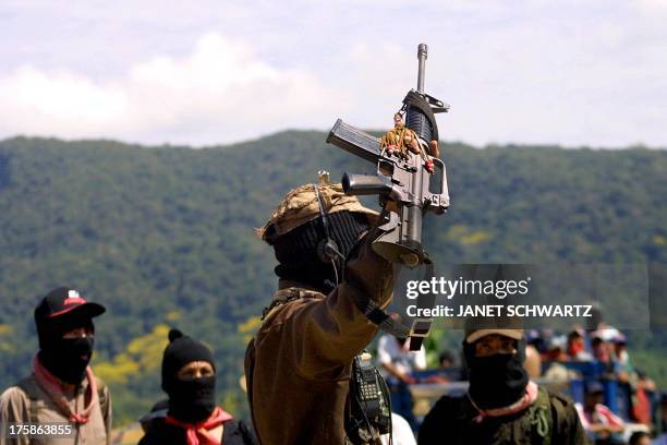 Subcommander Marcos , rebel leader of the Zapatista National Liberation Army , raises his assault rifle M-16 24 February 2001 in Realidad, Mexico,...