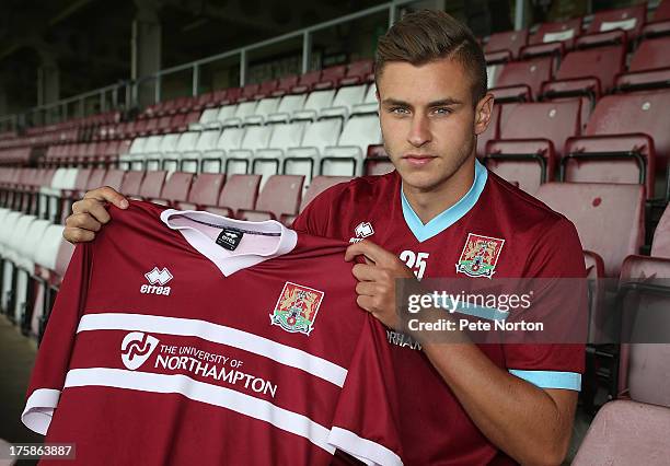 Northampton Town loan signing Jacob Blyth poses with a shirt during a photocall at Sixfields on August 9, 2013 in Northampton, England.