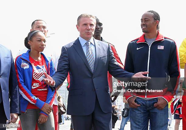 Vice-President Sergey Bubka speaks alongside Allyson Felix and Aries Merritt of the USA as they gather outside of St. Basil's Cathedral ahead of the...