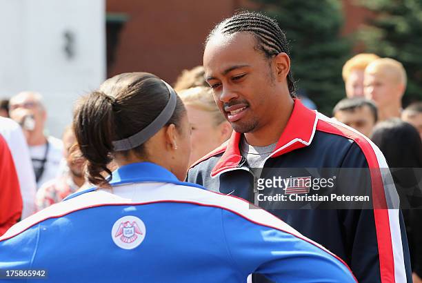 Aries Merritt and Allyson Felix of USA talk outside of St. Basil's Cathedral ahead of the 14th IAAF World Championships at on August 8, 2013 in...
