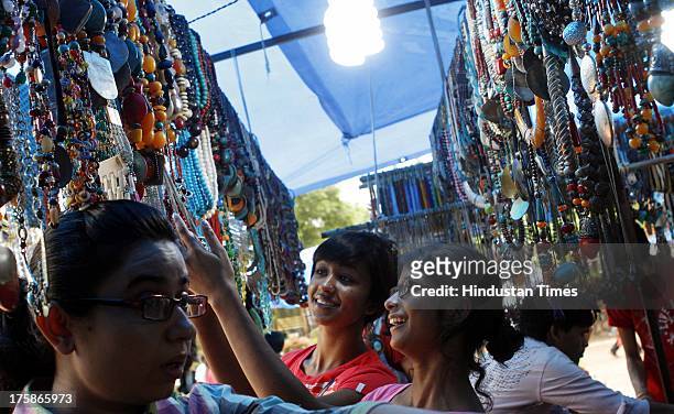 Girls enjoy the shopping on the day of Teej at Dilli Haat on August 9, 2013 in New Delhi, India. Hindu festival of Teej is to herald the onset of the...