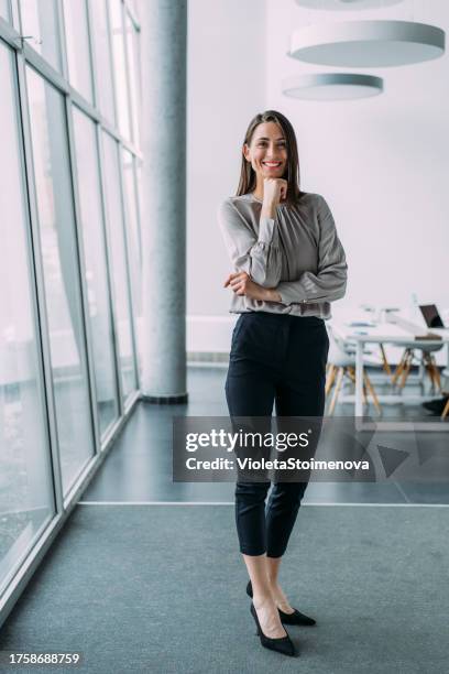 confident businesswoman in modern office. - whole stock pictures, royalty-free photos & images