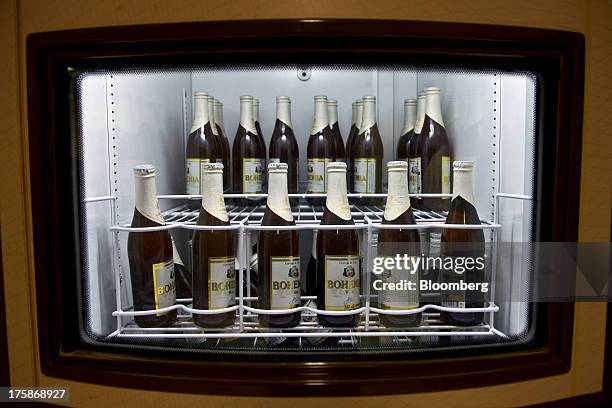 Bottles of Cia. De Bebidas das Americas Bohemia brand beer sit in a refrigerator at a restored Bohemia brewery in Petropolis, Brazil, Sunday, Aug. 4,...