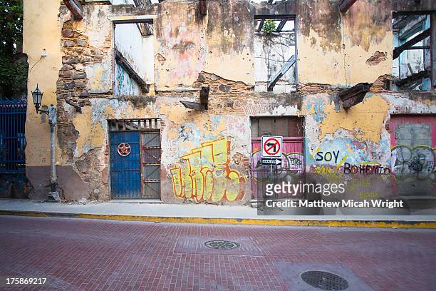 the graffiti lined buildings of old city at night - street　wall stock pictures, royalty-free photos & images