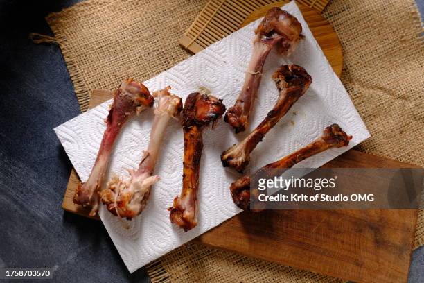 leftover chicken bones after eaten - chicken meat stock pictures, royalty-free photos & images