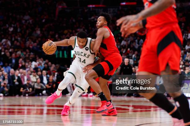 Giannis Antetokounmpo of the Milwaukee Bucks drives to the net against Scottie Barnes of the Toronto Raptors during the second half of their NBA game...