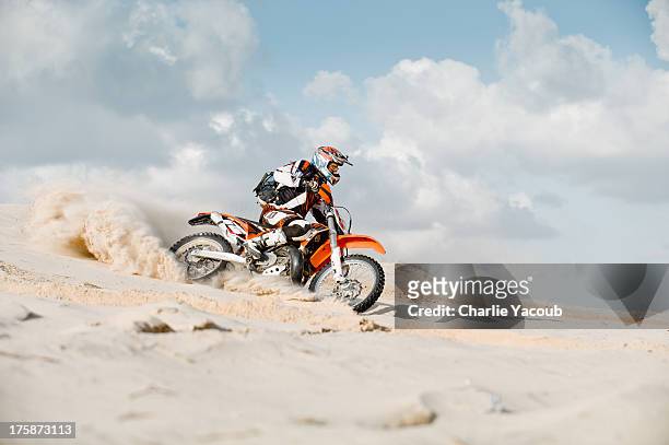 motor cross riding over sand - motocross stockfoto's en -beelden
