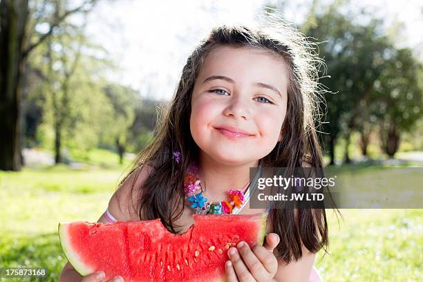 young girl eating watermelon, country side spain - 子供のみ ストックフォトと画像