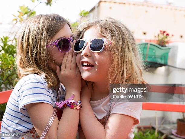 young girls whispering - child whispering stock-fotos und bilder