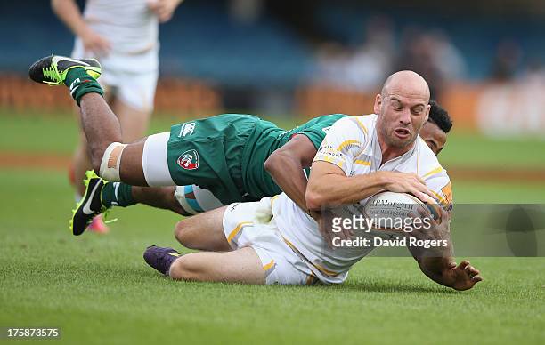 Paul Hodgson of Worcester Warriors is tackled by Tahir El Mahdi during the J.P. Morgan Asset Management Premiership 7's Series Finals at the...