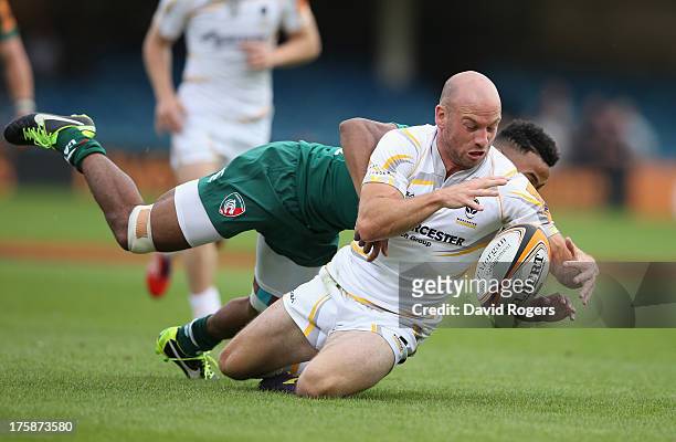 Paul Hodgson of Worcester Warriors is tackled by Tahir El Mahdi during the J.P. Morgan Asset Management Premiership 7's Series Finals at the...
