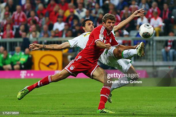 Thomas Mueller of Muenchen is challenged by Martin Stranzl of Moenchengladbach during the Bundesliga match between Bayern Muenchen and Borussia...