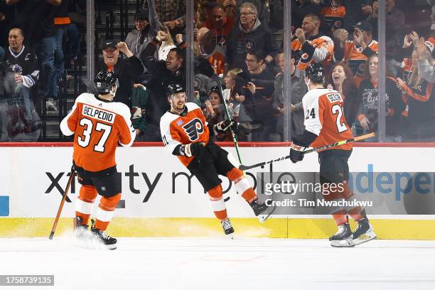 Louie Belpedio, Travis Konecny and Nick Seeler of the Philadelphia Flyers react following a goal by Konecny during the first period against the...